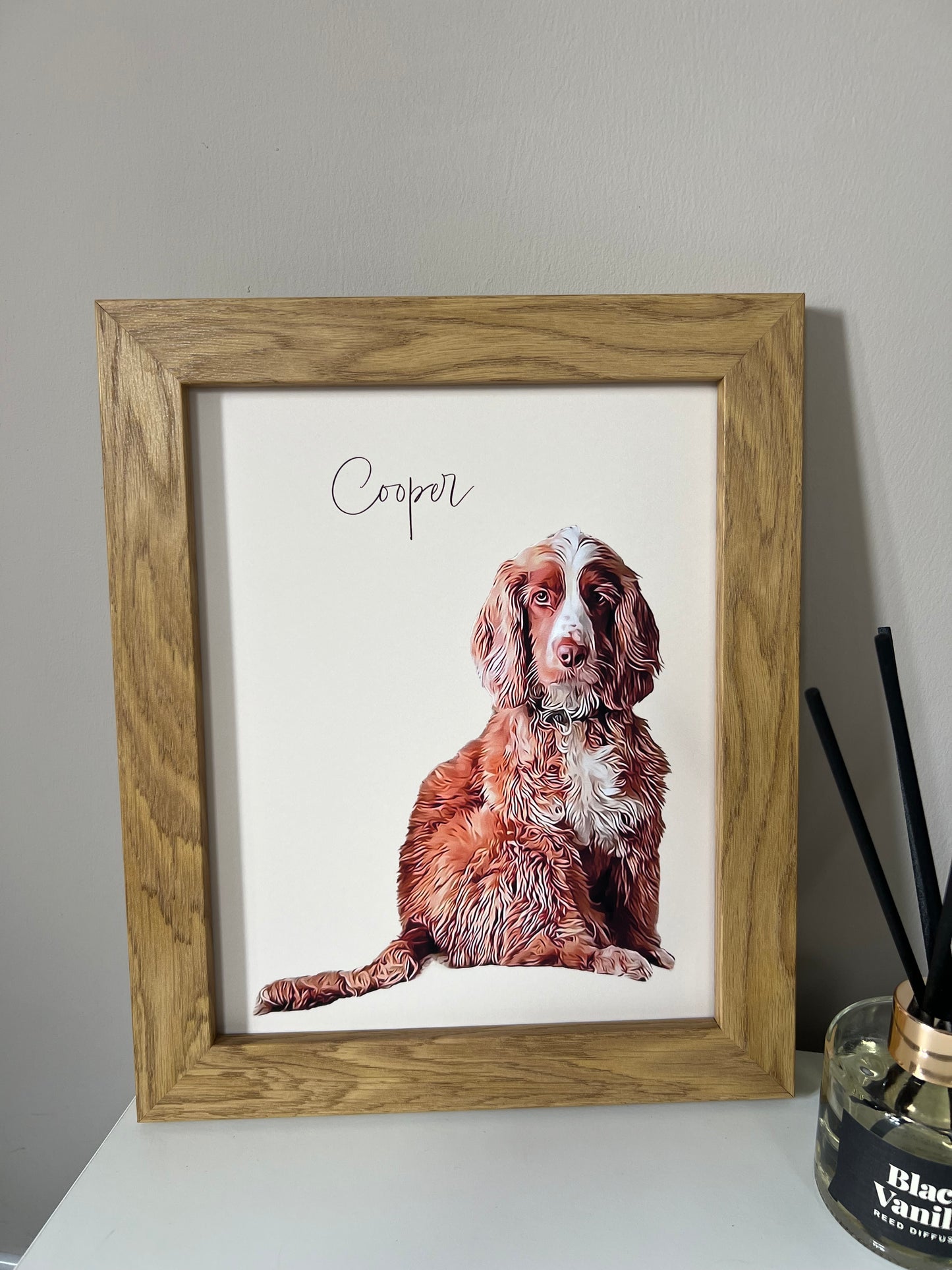 A custom digital pet portrait of a spaniel dog named Cooper, displayed in a wooden frame.