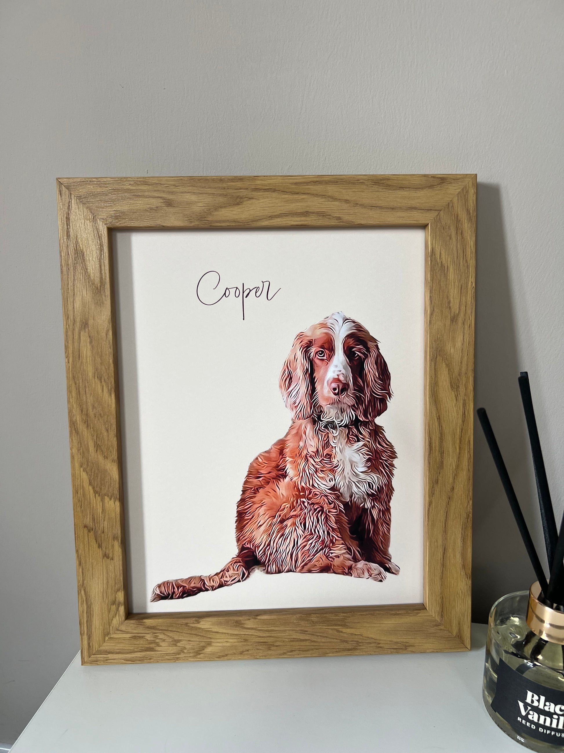 A custom digital pet portrait of a spaniel  dog named Cooper, displayed in a wooden frame.