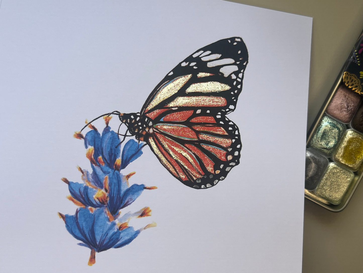 Monarch Butterfly illustration card with gold glitter accents on a white card with watercolour paints