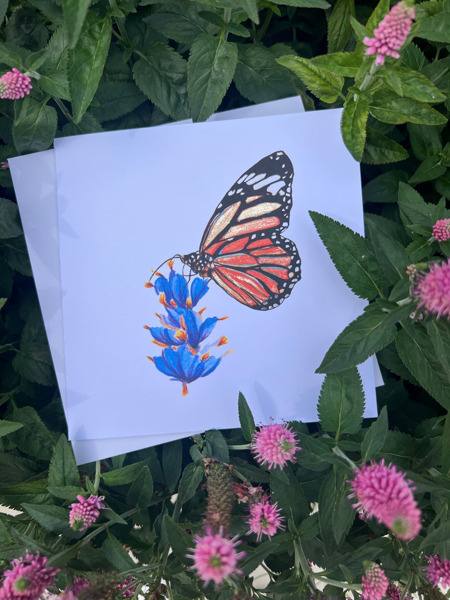 Monarch Butterfly illustration card with gold glitter accents on a white card with flowers and leaves around