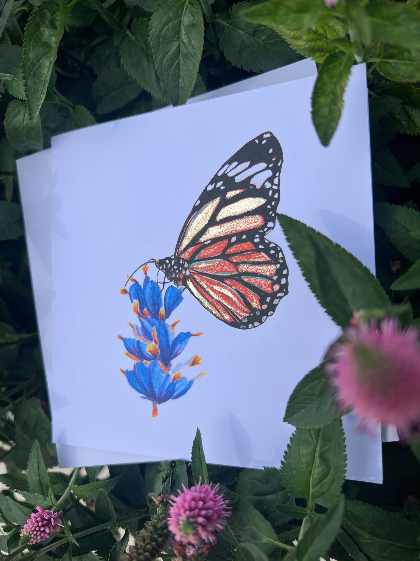 Monarch Butterfly illustration card with gold glitter accents on a white card with flowers and leaves around