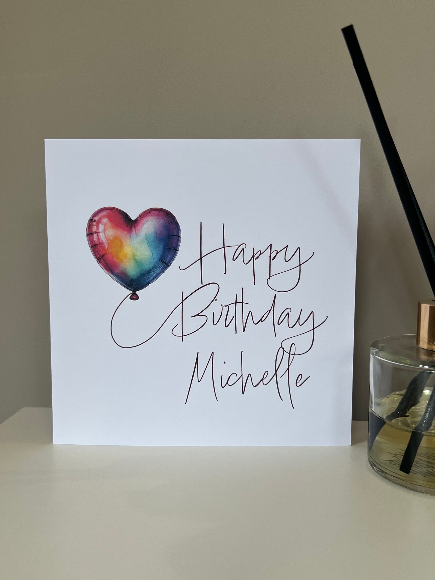 Birthday card with a heart-shaped balloon and personalized name.