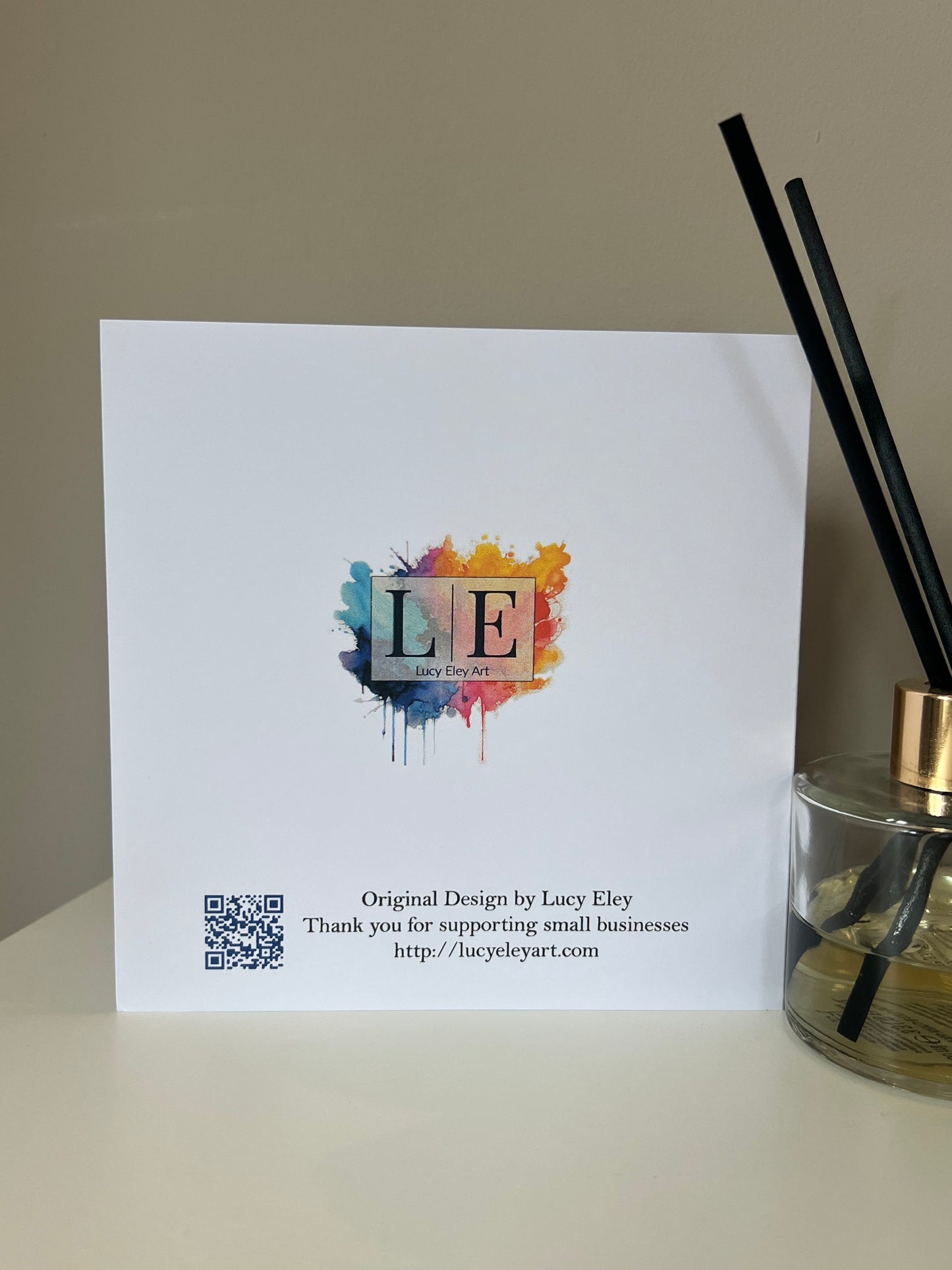 Rear of Handmade greeting card with colourful logo with a QR code and text on an white background