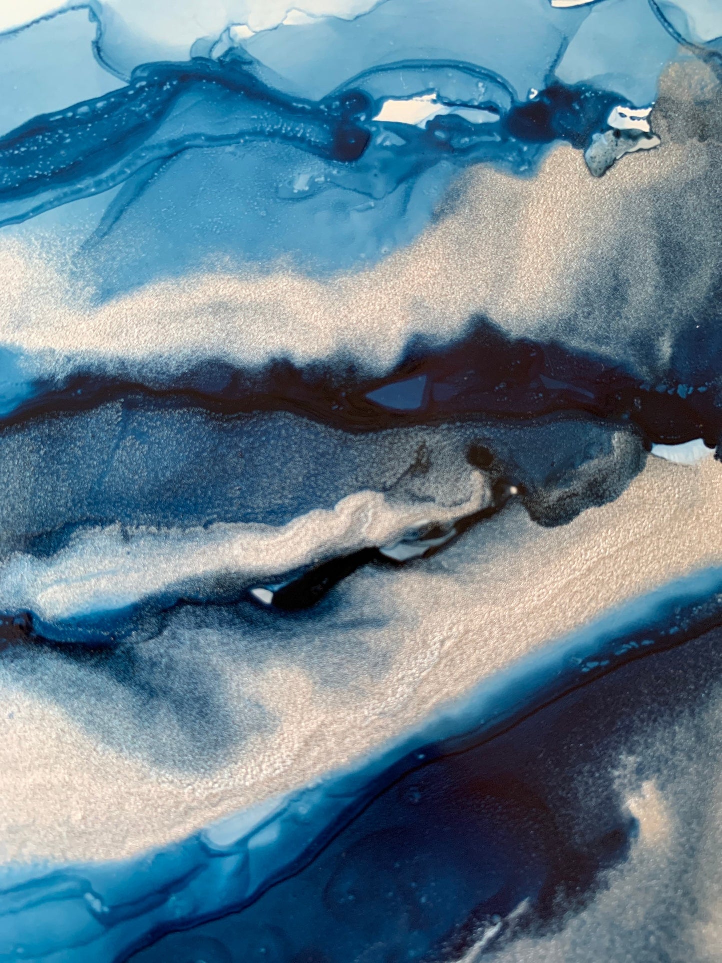 An abstract ink painting in shades of blue and silver, presented in a black mount.