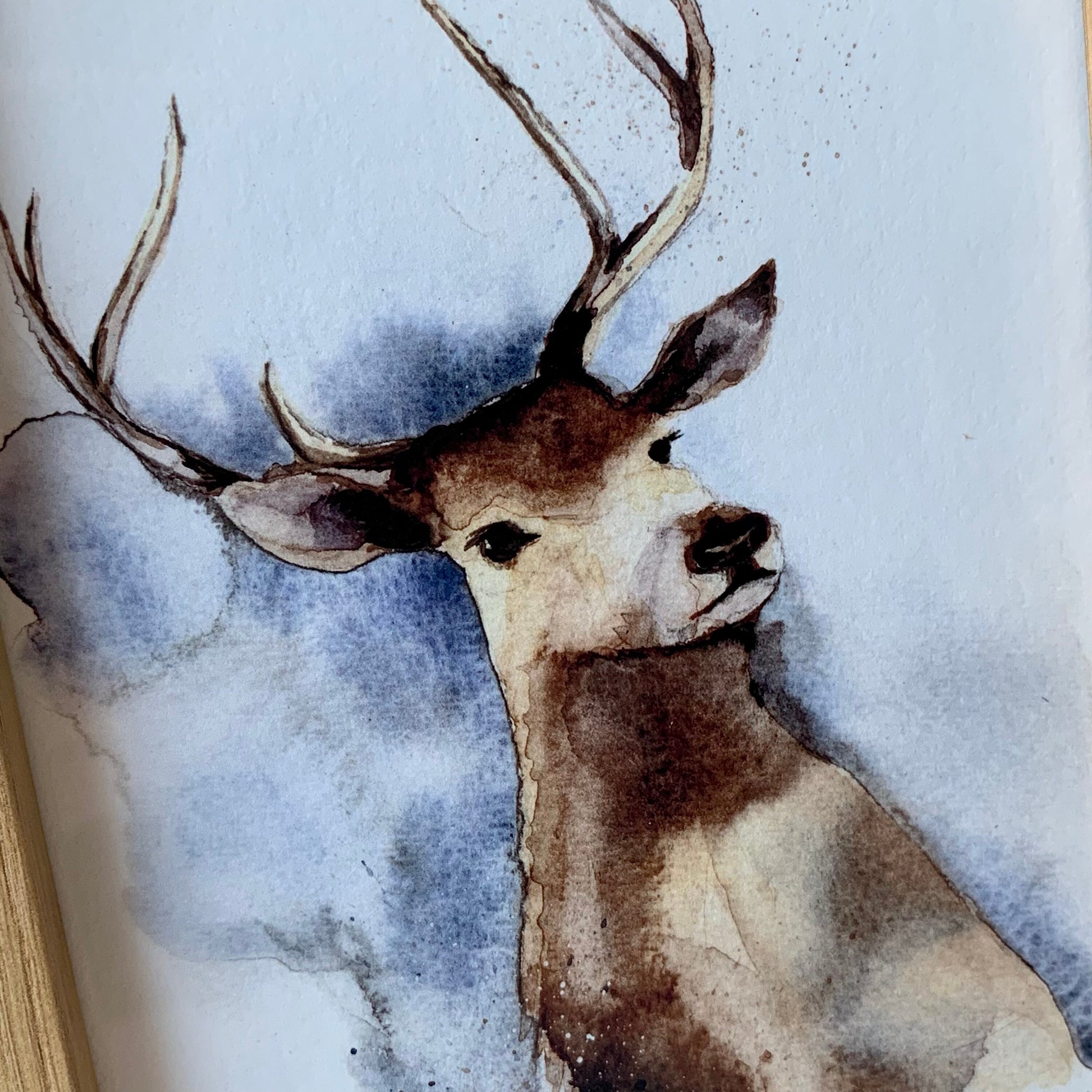 Close up of Watercolour stag in brown, grey and blue tones.