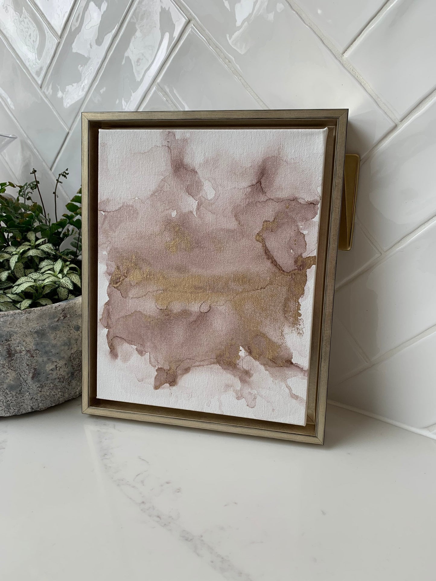 A 10x8 inch canvas with blush pink and gold metallic ink in an alcohol paint style, presented in a gold frame.