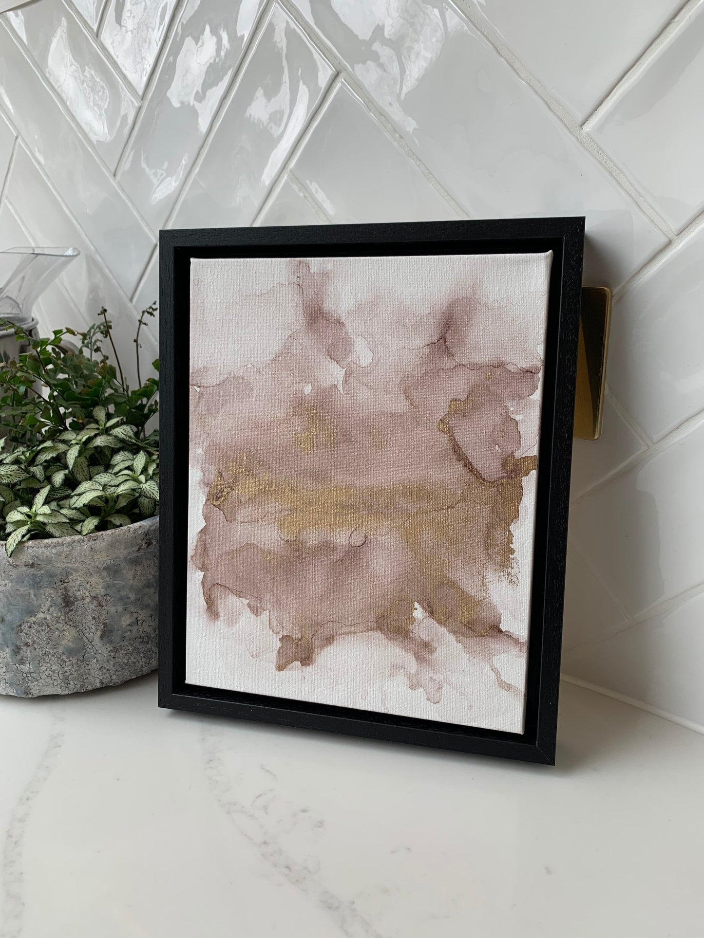 A 10x8 inch canvas with blush pink and gold metallic ink in an alcohol paint style, presented in a black frame.