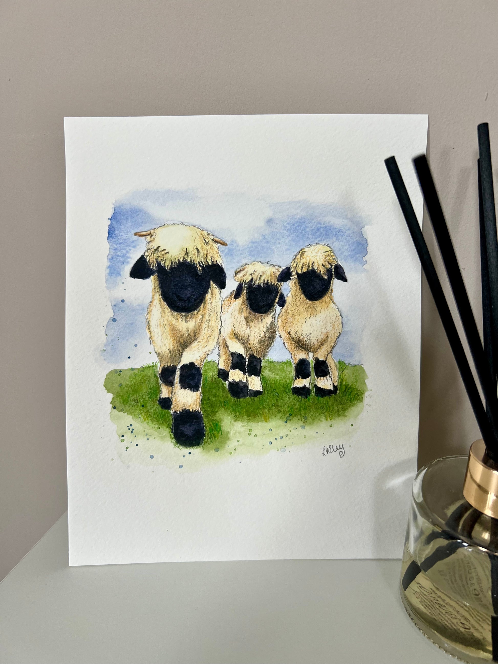A watercolor painting of three Valais Blacknose sheep standing in a field.