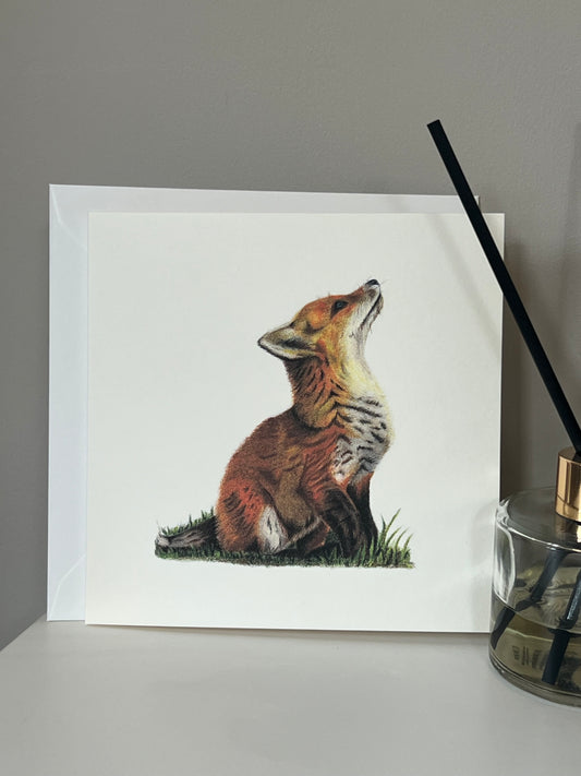 Handmade greeting card with artwork of a fox cub in vibrant oranges and yellows on an ivory background 