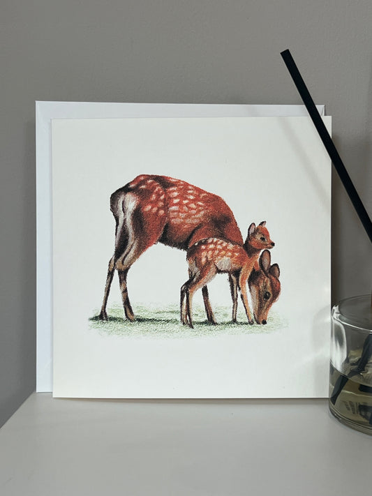 Handmade greeting card with artwork of a Sika Deer Mother and Fawn in vibrant oranges and reds on an ivory background 