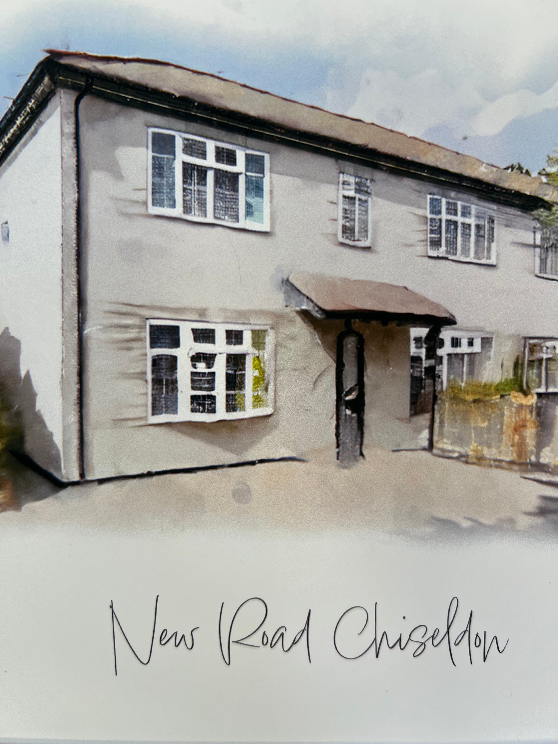 Close up of a framed artwork of a cottage house portrait in digital watercolour.