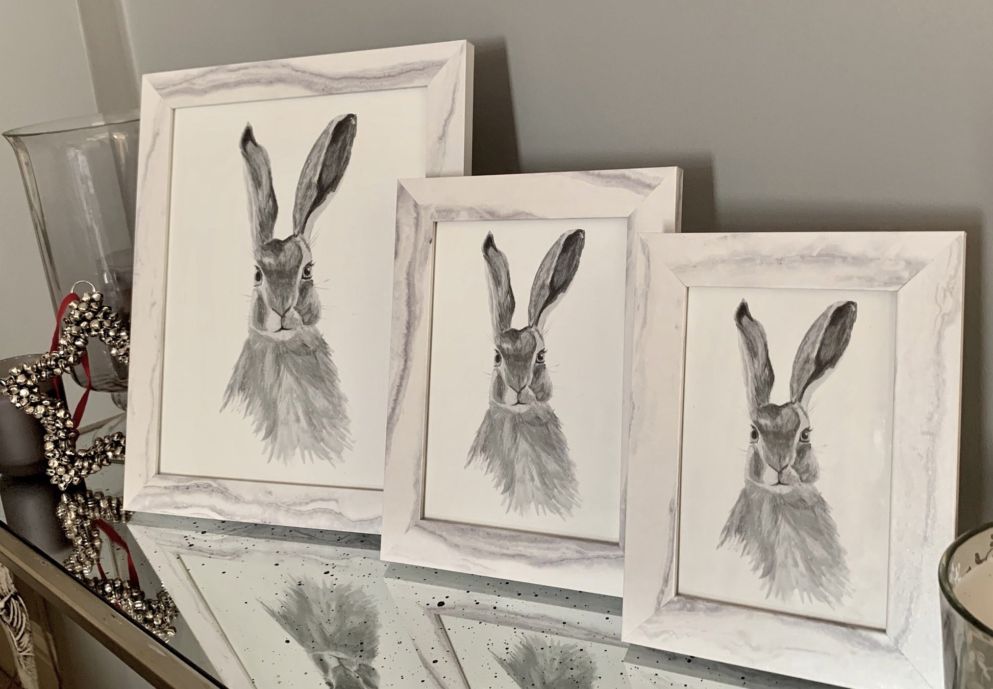 Watercolour hare in grey tones in a marble effect wooden frame.