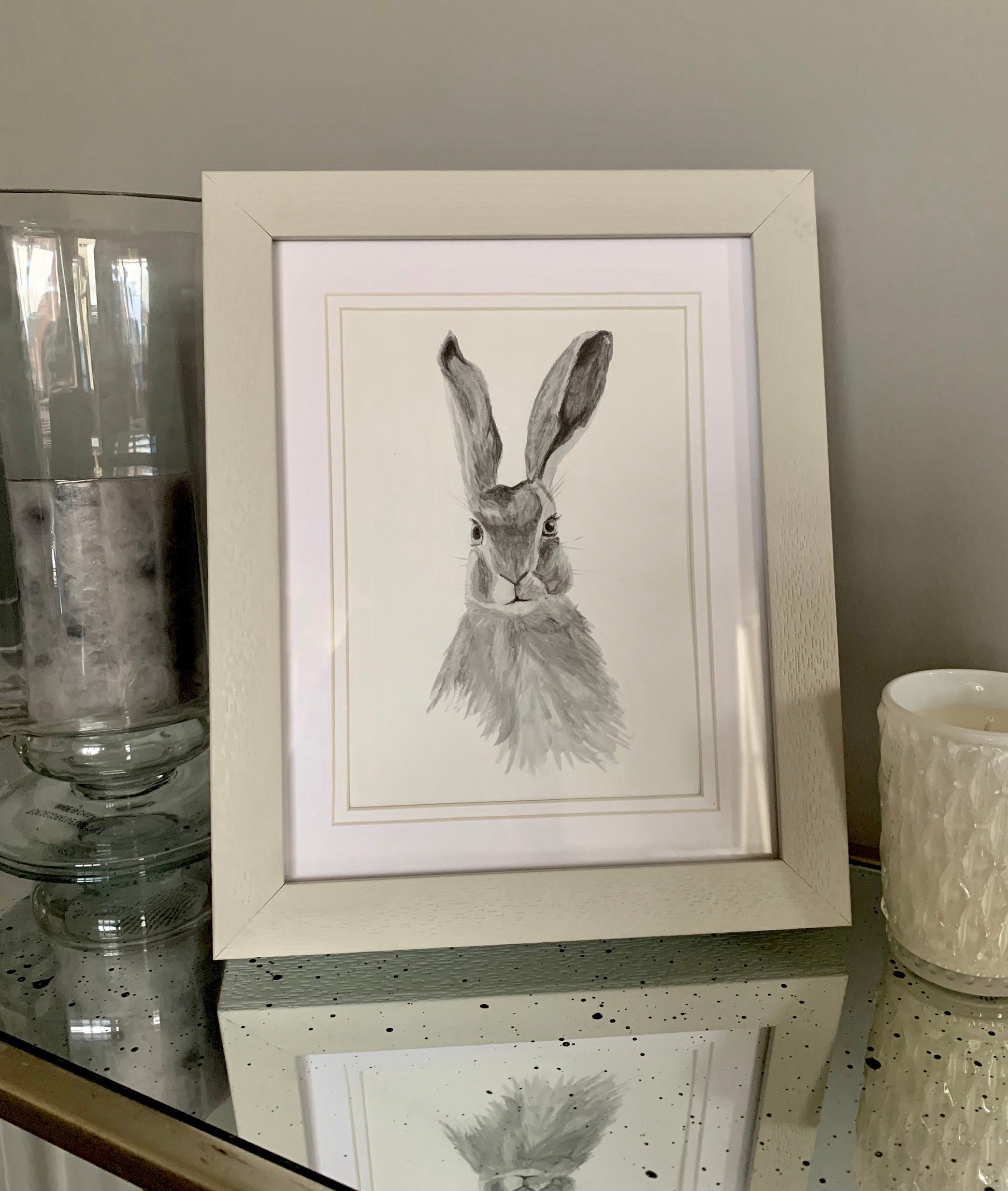 Watercolour hare in grey tones in a grey wooden frame with double mount.