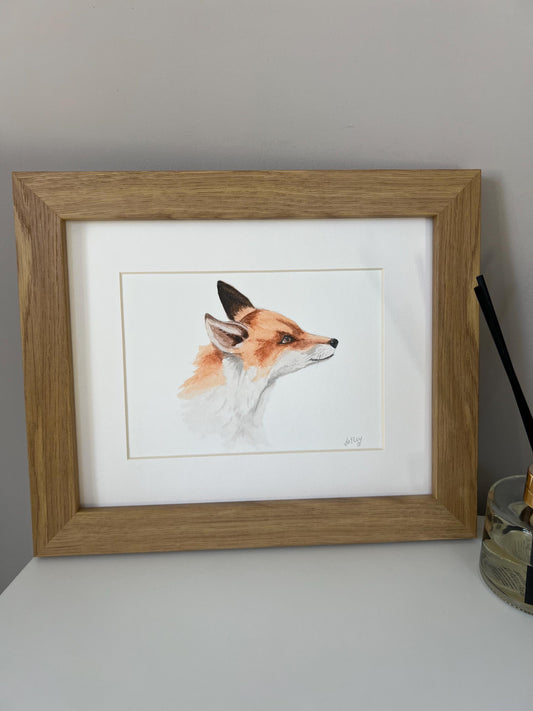 Watercolour young fox painting in brown and orange tones in a oak finish wooden frame with white mount. 